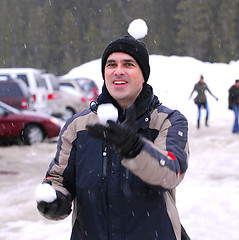 Image showing Man juggle snowballs