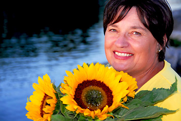 Image showing Woman sunflowers