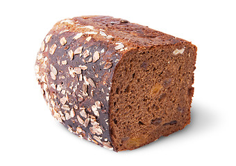 Image showing Lying half unleavened black bread with seeds and dried fruit