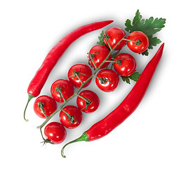 Image showing Two chili pepper and cherry tomatoes on stem with parsley