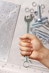 Image showing Hand holding spanner