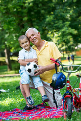 Image showing grandfather and child have fun  in park