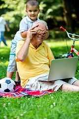 Image showing grandfather and child using laptop