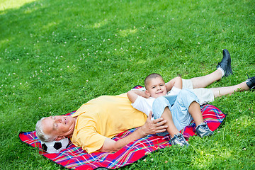 Image showing grandfather and child in park using tablet