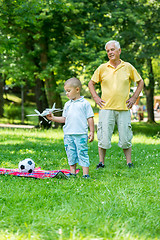 Image showing grandfather and child have fun  in park