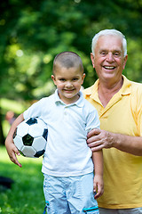 Image showing grandfather and child have fun  in park