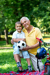 Image showing grandfather and child have fun  in park