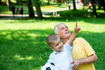 Image showing grandfather and child have fun  in park