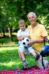 Image showing grandfather and child have fun  in park