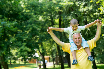 Image showing grandfather and child have fun  in park