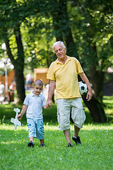 Image showing grandfather and child have fun  in park