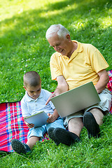 Image showing grandfather and child using laptop