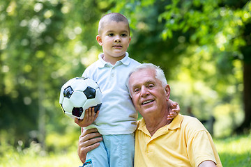 Image showing grandfather and child have fun  in park