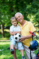 Image showing grandfather and child have fun  in park