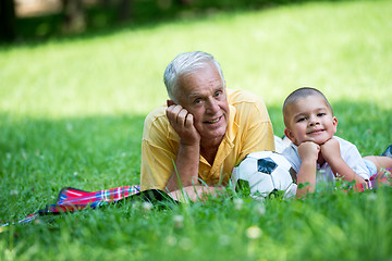 Image showing grandfather and child have fun  in park