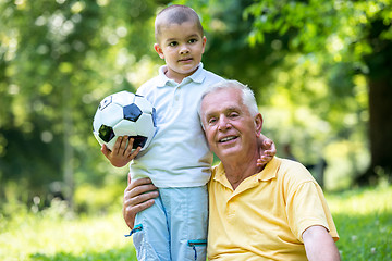 Image showing grandfather and child have fun  in park