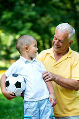 Image showing grandfather and child have fun  in park