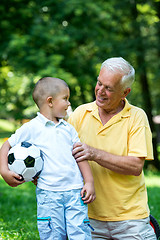 Image showing grandfather and child have fun  in park