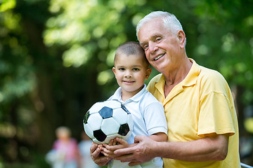 Image showing grandfather and child have fun  in park