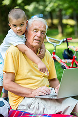 Image showing grandfather and child using laptop