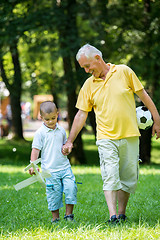 Image showing grandfather and child have fun  in park