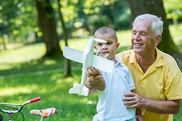 Image showing grandfather and child have fun  in park