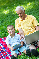 Image showing grandfather and child using laptop