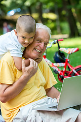 Image showing grandfather and child using laptop