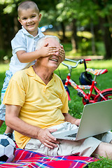 Image showing grandfather and child using laptop