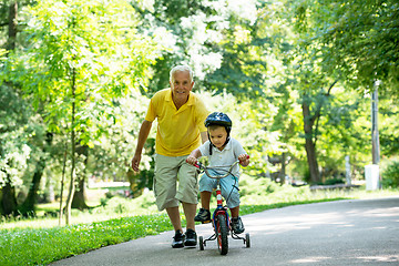 Image showing grandfather and child have fun  in park