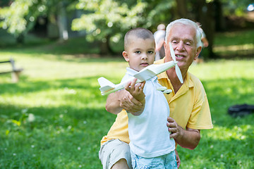 Image showing grandfather and child have fun  in park