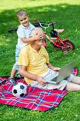 Image showing grandfather and child using laptop