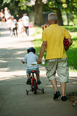 Image showing grandfather and child have fun  in park