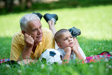 Image showing grandfather and child have fun  in park