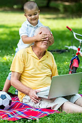 Image showing grandfather and child using laptop