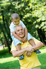 Image showing grandfather and child have fun  in park