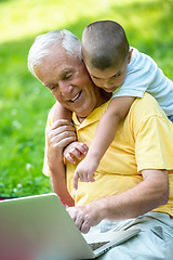 Image showing grandfather and child using laptop