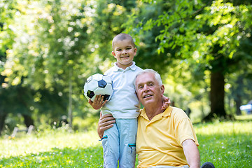 Image showing grandfather and child have fun  in park