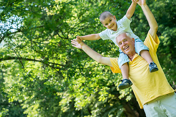 Image showing grandfather and child have fun  in park