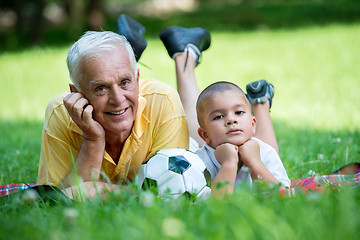 Image showing grandfather and child have fun  in park