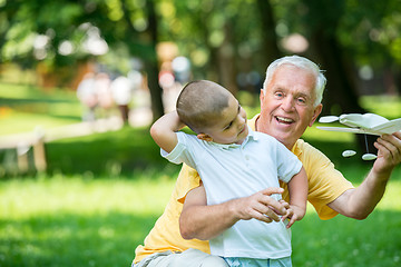 Image showing grandfather and child have fun  in park