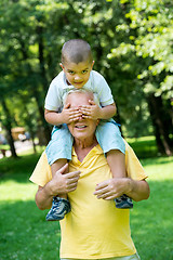 Image showing grandfather and child have fun  in park