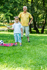 Image showing grandfather and child have fun  in park