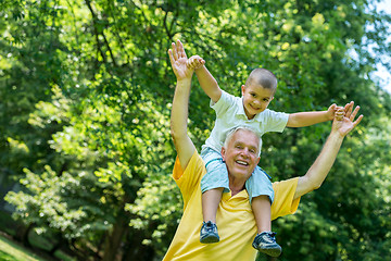 Image showing grandfather and child have fun  in park