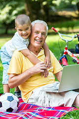 Image showing grandfather and child using laptop