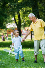 Image showing grandfather and child have fun  in park