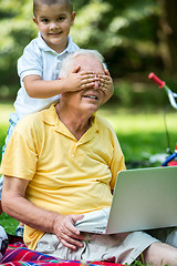 Image showing grandfather and child using laptop