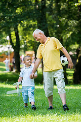 Image showing grandfather and child have fun  in park