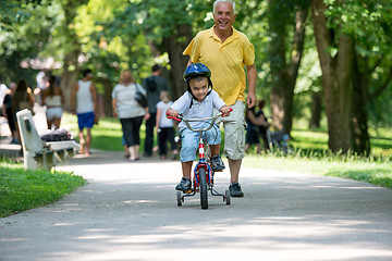 Image showing grandfather and child have fun  in park