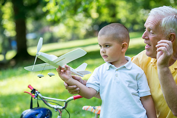 Image showing grandfather and child have fun  in park